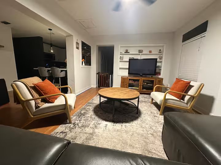Living room with leather sofa and mounted television