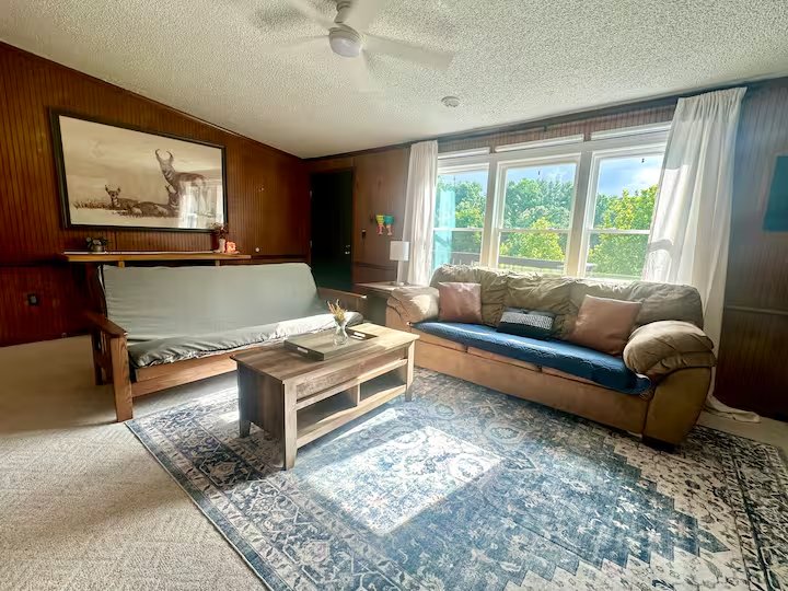 Living room seating area with large windows