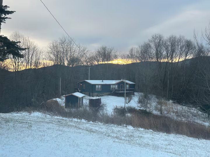House exterior in winter with snow on the ground