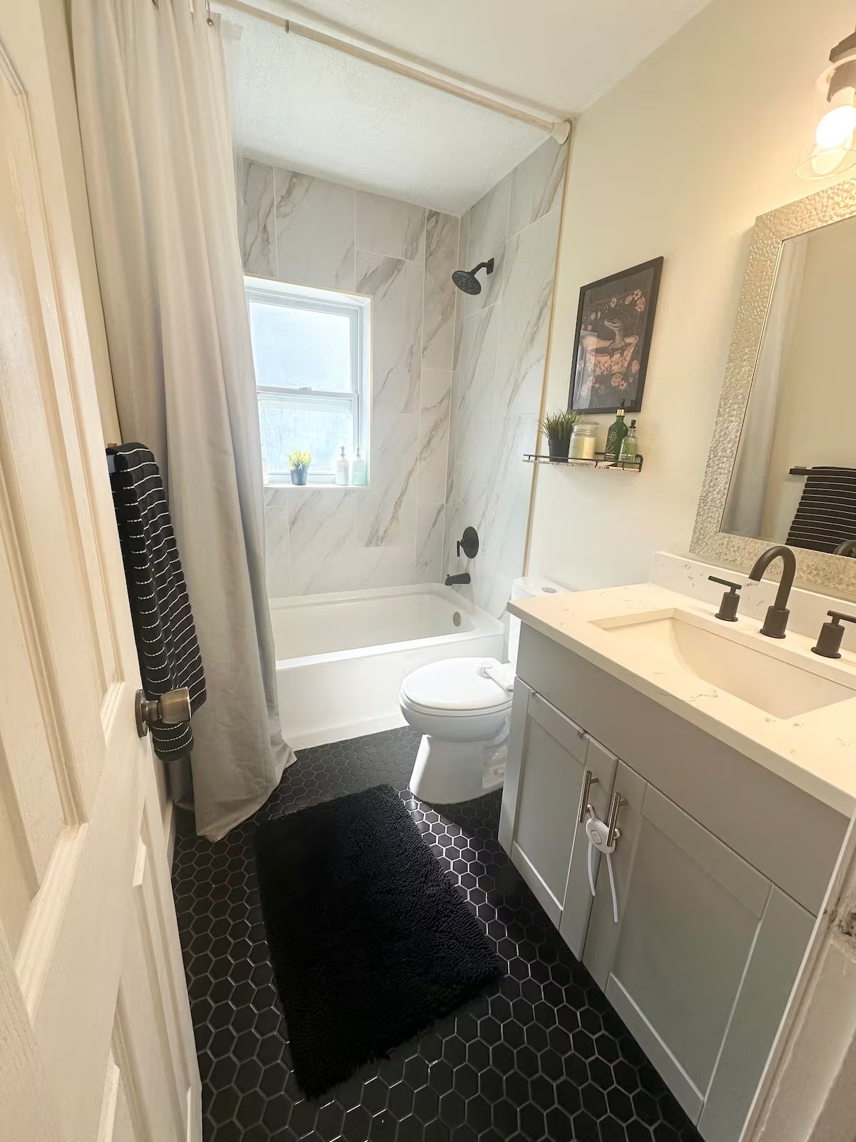 Bathroom with marble-tile shower surround