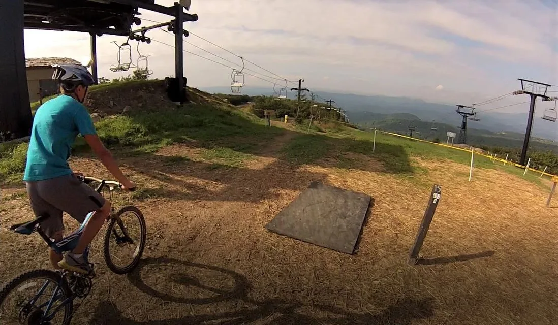 A mountain biker at the top of a lift-served trail at Beech Mountain Resort, North Carolina