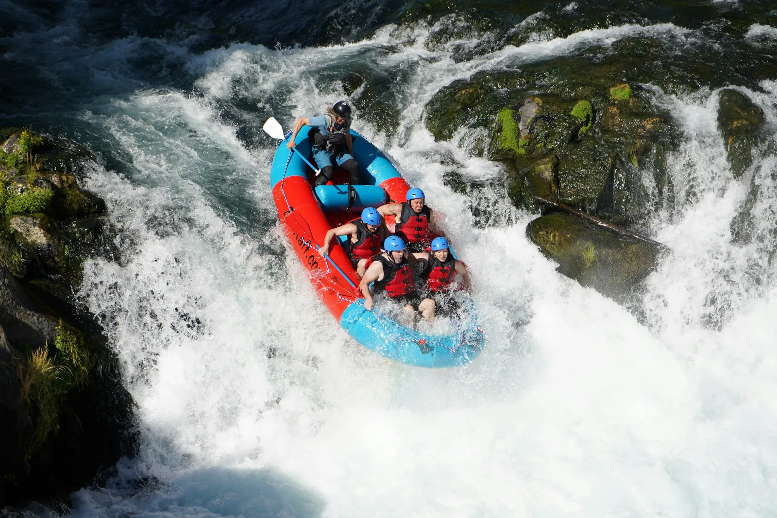 Guided whitewater rafting through rocky rapids